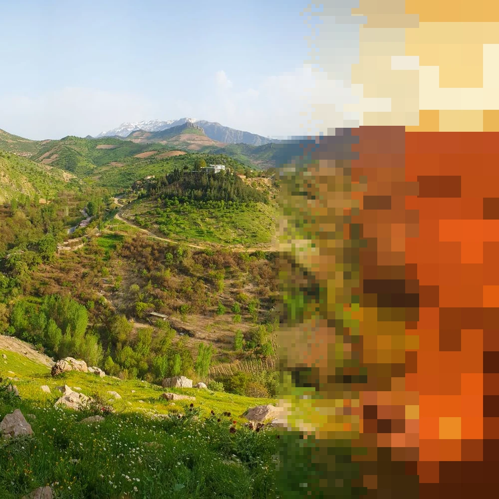 Green hills and terraced valleys under a pale sky, the right side breaking into ember pixels